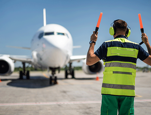 airplane runway person leading plane airplane runway person leading plane