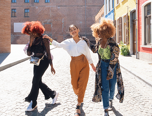 three girls walking down street three girls walking down street