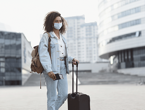 person in mask with luggage person in mask with luggage
