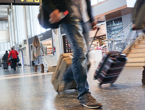 walking-through-airport-with-suitcase walking-through-airport-with-suitcase
