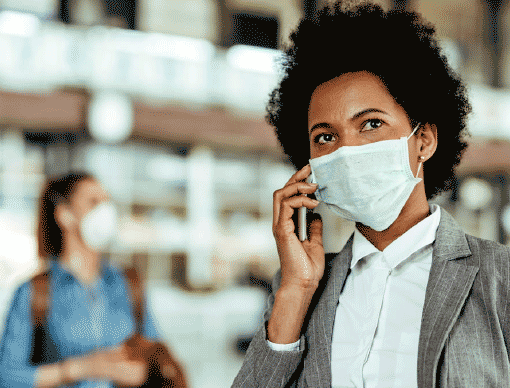 person with mask on phone person with mask on phone